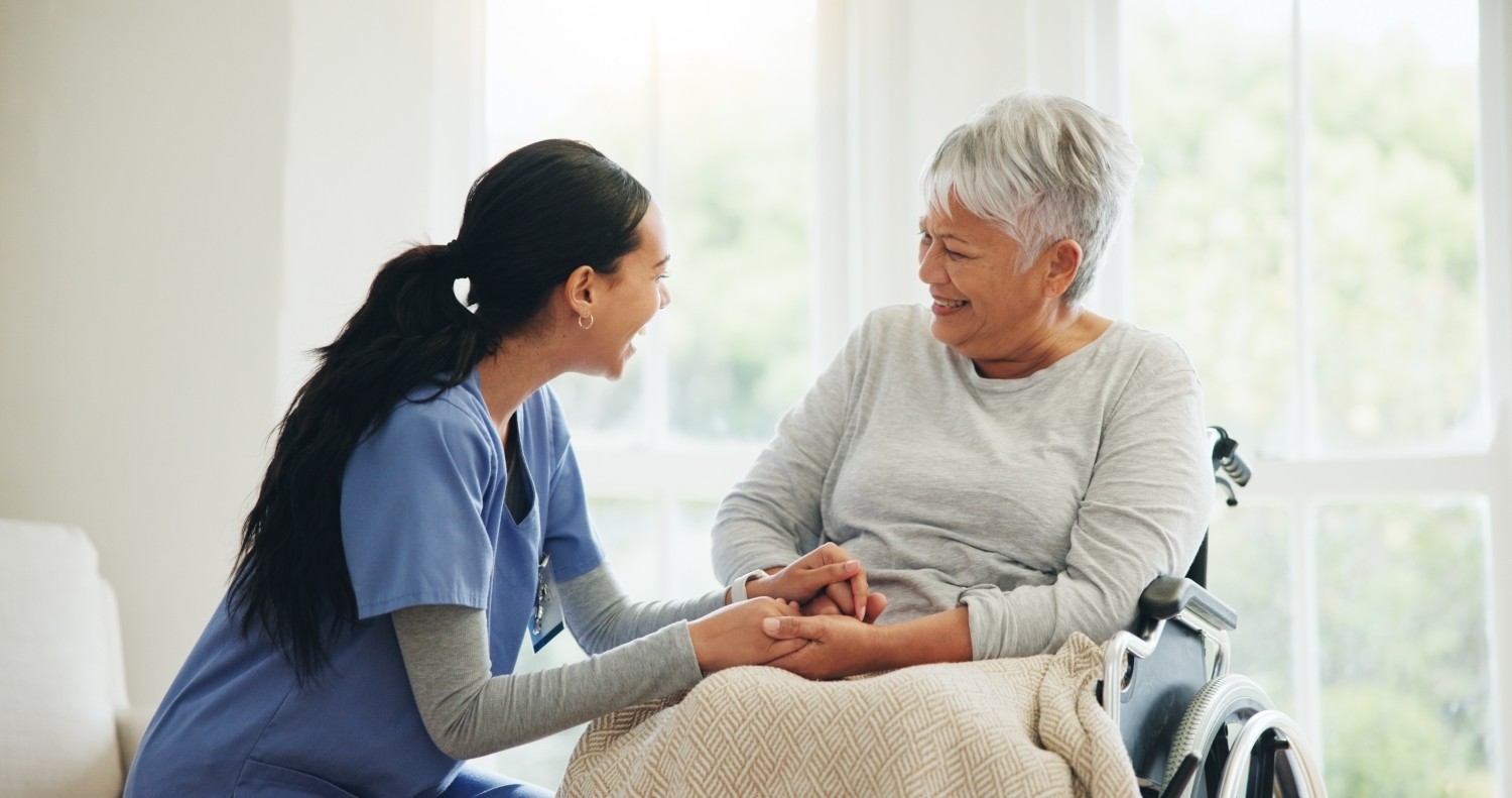 A support worker sitting with an older woman in her living room